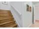 Hardwood staircase with white banister and neutral wall decor at 5077 Capulet Circle, Myrtle Beach, SC 29588