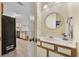 Attached bathroom with neutral color scheme; it includes a sink with vanity and round mirror at 510 Fairwood Lakes Ln. # 20E, Myrtle Beach, SC 29588