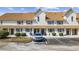 Charming multi-Gathering building with beige siding, brown shutters, and reserved handicap parking at 510 Fairwood Lakes Ln. # 20E, Myrtle Beach, SC 29588