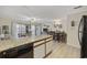 Open-concept living room featuring dining area, lots of natural light, and wood look floors at 510 Fairwood Lakes Ln. # 20E, Myrtle Beach, SC 29588