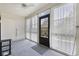 A bright and airy sunroom, featuring sheer curtains, multiple windows, and a ceiling fan at 510 Fairwood Lakes Ln. # 20E, Myrtle Beach, SC 29588