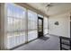 The sunroom includes multiple windows, sheer curtains, a ceiling fan, and access to outside at 510 Fairwood Lakes Ln. # 20E, Myrtle Beach, SC 29588