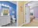 View from hallway of blue powder room with granite vanity and glimpses of the next room at 5825 Catalina Dr. # 531, North Myrtle Beach, SC 29582