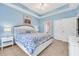 Bright bedroom with large windows, a queen-size bed, and stylish, cool blue décor at 5825 Catalina Dr. # 531, North Myrtle Beach, SC 29582