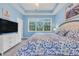 Bright bedroom with large windows, a queen-size bed, and stylish, cool blue décor at 5825 Catalina Dr. # 531, North Myrtle Beach, SC 29582