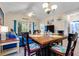 Open floor plan with dining table, living area with blue sofa, and sliding glass doors to the outside at 5825 Catalina Dr. # 531, North Myrtle Beach, SC 29582