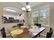 Bright dining room with a wooden table set for four near a window and open to the kitchen at 5825 Catalina Dr. # 531, North Myrtle Beach, SC 29582