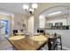 Warm dining area shows wooden table set for four, a decorative shelf and an opening to the kitchen at 5825 Catalina Dr. # 531, North Myrtle Beach, SC 29582