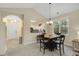 Inviting dining area featuring a wooden table, chandelier, and an archway to the entry and kitchen at 5825 Catalina Dr. # 531, North Myrtle Beach, SC 29582
