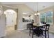 Inviting dining area featuring a wooden table, chandelier, and an archway to the entry and kitchen at 5825 Catalina Dr. # 531, North Myrtle Beach, SC 29582