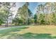 Lush grassy view of the community with mature trees and the condo building in the distance at 5825 Catalina Dr. # 531, North Myrtle Beach, SC 29582