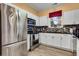 Bright kitchen featuring stainless steel appliances, white cabinets, and laminate flooring at 5825 Catalina Dr. # 531, North Myrtle Beach, SC 29582