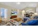 Open-concept living area with a TV, blue sofa, and dining area connected to the kitchen at 5825 Catalina Dr. # 531, North Myrtle Beach, SC 29582