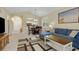 Cozy living space featuring a comfortable blue sofa, a wooden table, and an open view of the dining area at 5825 Catalina Dr. # 531, North Myrtle Beach, SC 29582