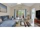 Bright living room with a comfortable blue sofa, sliding glass doors to the deck and neutral-toned walls at 5825 Catalina Dr. # 531, North Myrtle Beach, SC 29582