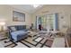 Bright living room with a comfortable blue sofa, sliding glass doors to the deck and neutral-toned walls at 5825 Catalina Dr. # 531, North Myrtle Beach, SC 29582