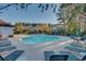 Community pool with a view of the condos and surrounded by many trees and lounge chairs at 5825 Catalina Dr. # 531, North Myrtle Beach, SC 29582