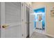 Bright powder room showcasing the vanity and glimpse into the stylishly decorated blue bathroom at 5825 Catalina Dr. # 531, North Myrtle Beach, SC 29582