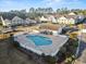 Aerial view of a sparkling community pool and surrounding condo buildings with manicured landscaping at 5834 Longwood Dr. # 303, Murrells Inlet, SC 29576