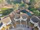Aerial view of condo buildings with a fountain pond in the community and adjacent golf course at 5834 Longwood Dr. # 303, Murrells Inlet, SC 29576