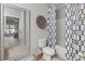 Well-lit bathroom featuring a tub, decorative shower curtain, toilet, and vanity at 5834 Longwood Dr. # 303, Murrells Inlet, SC 29576