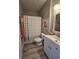 Clean bathroom with a white vanity, striped shower curtain, and modern fixtures at 5834 Longwood Dr. # 303, Murrells Inlet, SC 29576