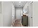 A bright, neutral foyer showcasing wood-look floors, a decorative cabinet, and white trim at 5834 Longwood Dr. # 303, Murrells Inlet, SC 29576
