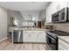 Open-concept kitchen with stainless steel appliances and an island featuring granite countertops at 5834 Longwood Dr. # 303, Murrells Inlet, SC 29576