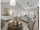 Bright, open-concept living room with chandelier and plenty of natural light at 5834 Longwood Dr. # 303, Murrells Inlet, SC 29576