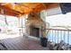 Outdoor porch with a stone fireplace, wood-beamed ceiling, and water views at 5865 Creekside Dr., Myrtle Beach, SC 29588