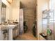 Accessible bathroom featuring a walk-in shower, pedestal sink, and ample shelving at 5865 Creekside Dr., Myrtle Beach, SC 29588