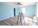 Bright bedroom with light blue walls, gray flooring and a ladder in the center at 5865 Creekside Dr., Myrtle Beach, SC 29588