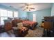 A bright bedroom with a ceiling fan, brown recliner, and decorative carpet at 5865 Creekside Dr., Myrtle Beach, SC 29588