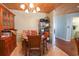 Cozy dining area features a round glass table, wood chairs, and a charming chandelier at 5865 Creekside Dr., Myrtle Beach, SC 29588