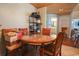 Inviting dining area featuring a round glass table with wood accents and an adjacent hutch at 5865 Creekside Dr., Myrtle Beach, SC 29588
