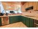 Charming kitchen with unique tile countertops, stainless steel appliances, and green lower cabinets at 5865 Creekside Dr., Myrtle Beach, SC 29588