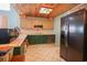 Cozy kitchen featuring tile countertops, modern appliances, and light colored upper cabinets at 5865 Creekside Dr., Myrtle Beach, SC 29588