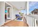 Covered porch with wicker seating and view to the neighborhood, and an entry to the home at 6001-N50 S Kings Hwy., Myrtle Beach, SC 29575