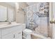 Nautical-themed bathroom with vanity, toilet, and shower with a ship-patterned curtain at 6001-N50 S Kings Hwy., Myrtle Beach, SC 29575