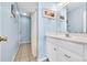 Bathroom features a single sink vanity with storage, tile flooring, and a shower with blue painted walls at 6001-N50 S Kings Hwy., Myrtle Beach, SC 29575