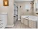 Bathroom featuring a soaking tub, tiled floors, and decorative coastal accents at 6001-N50 S Kings Hwy., Myrtle Beach, SC 29575