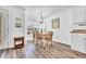 Cozy dining area with table, seating for six, chandelier lighting, and natural light from the window at 6001-N50 S Kings Hwy., Myrtle Beach, SC 29575