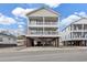 Charming raised beach house with ample parking and storage underneath, showcasing its coastal architecture at 6001-N50 S Kings Hwy., Myrtle Beach, SC 29575