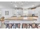 Bright kitchen features white cabinetry, matching appliances, and a kitchen island with barstool seating at 6001-N50 S Kings Hwy., Myrtle Beach, SC 29575