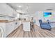 Bright kitchen flows to living area, featuring white cabinets, breakfast bar, and modern appliances at 6001-N50 S Kings Hwy., Myrtle Beach, SC 29575