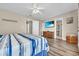 Large bedroom with wood-look floors, a TV, and an en-suite bathroom at 6001-N50 S Kings Hwy., Myrtle Beach, SC 29575