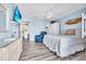Spacious main bedroom includes a television, ceiling fan, coastal decor, and an ensuite bathroom at 6001-N50 S Kings Hwy., Myrtle Beach, SC 29575