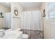 Well-lit bathroom featuring a shower-tub combination, vanity with sink, and decorative wreath at 6001-Z-26 South Kings Hwy., Myrtle Beach, SC 29575