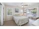 Bright bedroom with a ceiling fan, two windows, sliding glass doors to the deck, and light neutral decor at 6001-Z-26 South Kings Hwy., Myrtle Beach, SC 29575