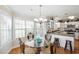 Bright breakfast nook features a glass table, ornate chairs, and sun-drenched windows at 6001-Z-26 South Kings Hwy., Myrtle Beach, SC 29575